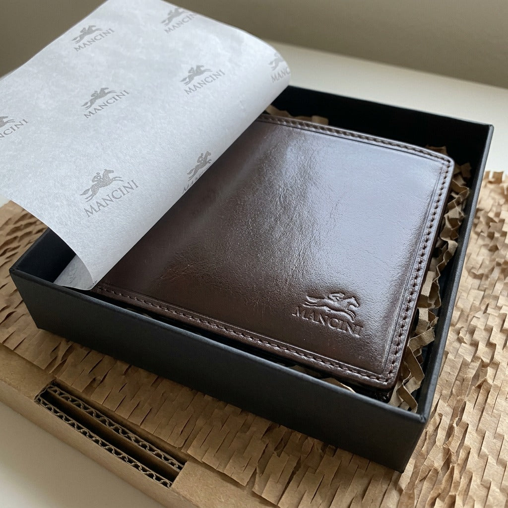 A photograph of the open Mancini leather wallet on a wooden surface, surrounded by protective tissue and a brown box, reducing shipping damage concerns.
